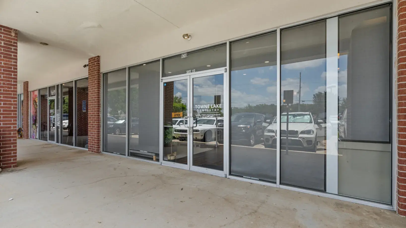 a building with a lot of windows and cars parked in the parking lot